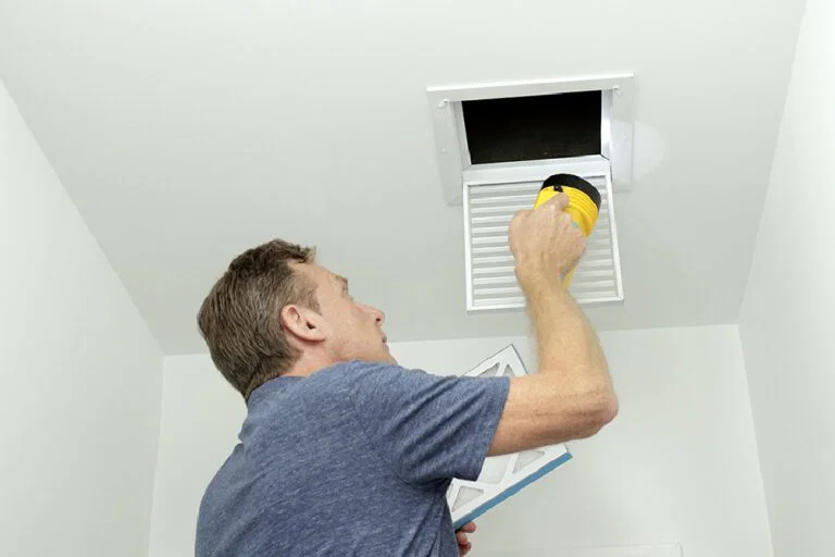 Middleton AC Services technician servicing an HVAC system in Middleton, ID
